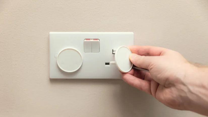 Electrical Safety for Kids. Putting socket covers on electrical outletes