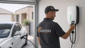 EV Technician setting up an EV charger in a garage. Charger is connected to a vehicle. Home EV Charging Rockingham