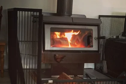 Jarrahdale wood heater with safety guard around and fire on the go